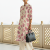 Cotton floral kurta set side pose with handbag